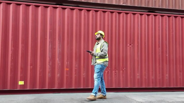 Labor Labour male white skin person people human yellow hardhat safety uniform walking check list inspect import export logistic container examining work job occupation factory cfr freight control box