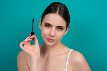 Woman comb eyelashes with eyelashes brush. Care for lashes, eyebrows lamination. Eyelashes beauty...