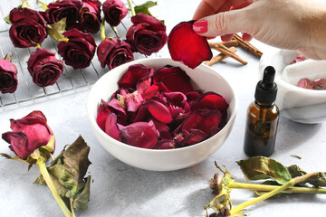 Making homemade rose potpourri by drying roses petals and adding essential oils spices, DIY