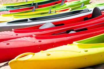 multi-colored canoes on the sand 
