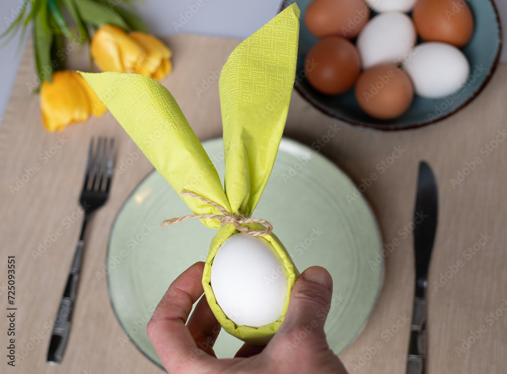 Wall mural egg wrapped in bunny shaped napkin