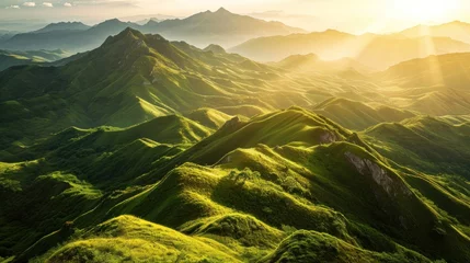 Poster a green mountains with sun shining through the mountains © sam