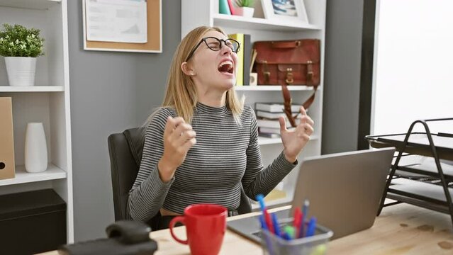 Blonde woman feeling joy then stress while working indoors at her office