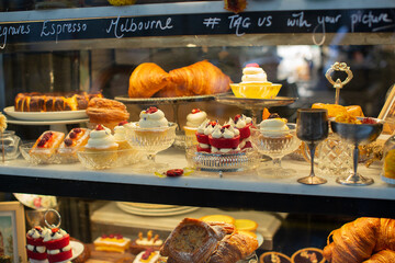 Melbourne, Victoria, Australia, August 7, 2023: View of cakes and pastries through the window of a small bakery shop in the heart of Melbourne.