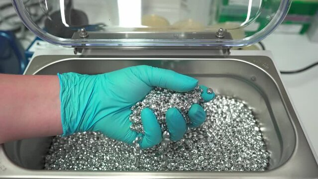 Metal pellets for the water bath . High quality 4k footage. Replace water in laboratory baths . The thermal metallic beads