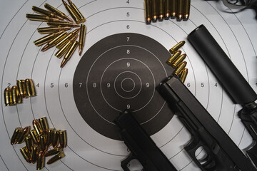 Firearms, paper target for shooting, pistols, silencer and cartridges. - obrazy, fototapety, plakaty