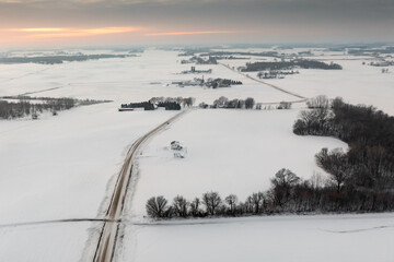 Road Into Winter Landscape of Farms Fields and Forests