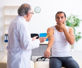 Fototapeta premium Young male patient visiting experienced doctor