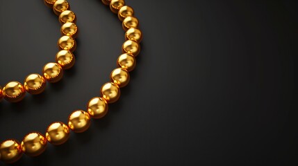 Obraz premium A golden bead necklace on a dark background. Can be used in jewelry advertisements or luxury item showcases, embodying the concept of opulence. Banner with copy space
