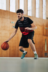 A fit professional basketball player in action dribbling a ball on court.