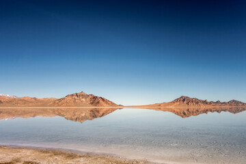 Mountains reflected in the Great Salt Lake outside of Salt Lake City, Utah, US.