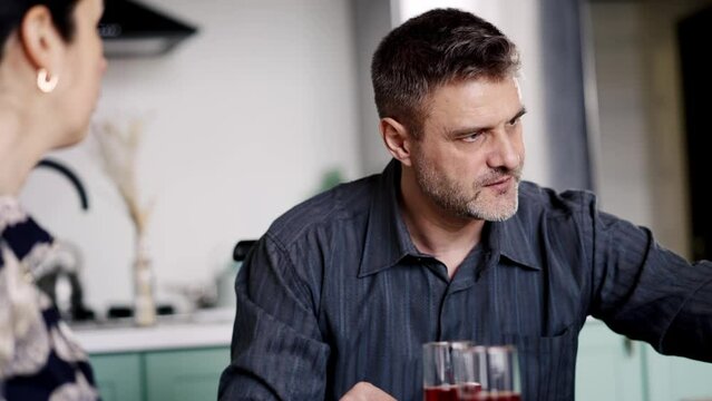 A protestants family dispute. Angry father punishment for his daughter when wife telling him truth about bad marks in school. Stressful dialogue with parents. Daddy scolding child at dining table 