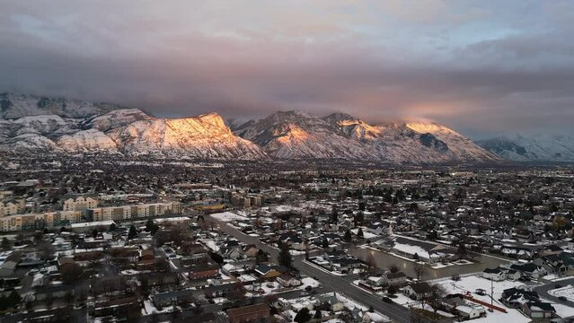 Flying over Utah Valley during winter at sunset as light hits the mountains.