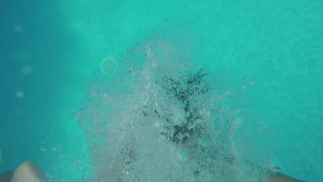 Selfie of man with boy and girl falling backwards in swimming pool at hotel. 