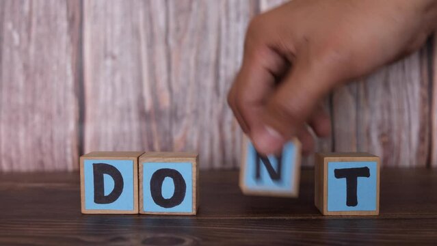Human hand change word don't to do it. Motivation concept.