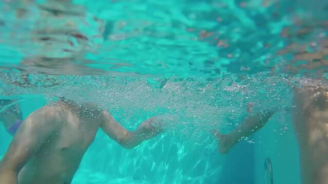 Boy and girl mr splash each other in pool at Novotel hotel