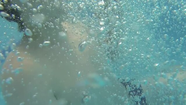 Selfie of boy near girl jumping with summersault in pool 