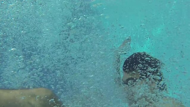 Selfie of man near woman, boy, girl jumping in pool of hotel Caesar Domus