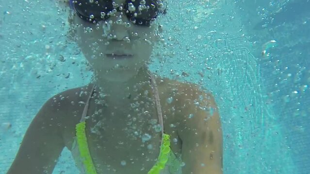 Selfie of girl jumping in pool of hotel Caesar Domus, slow motion.