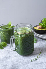 Blended green smoothie with ingredients. Healthy smoothie