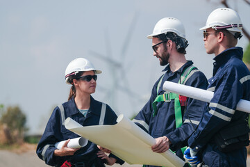 engineers working in fieldwork outdoor. Workers walking and inspect construction and machine around project site. Wind turbine electrical of clean resource enerdy and environment sustainable. - obrazy, fototapety, plakaty