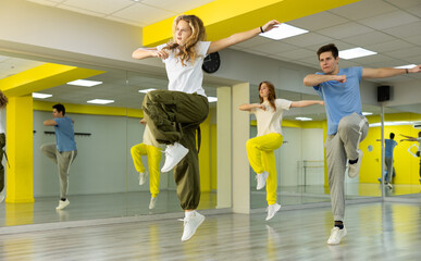 Teen girl in wide pants dancing hip hop dancing in dance studio