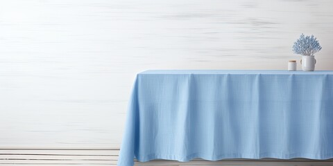 Mock up design featuring a blue tablecloth on a white wooden table with copy space.
