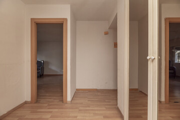 Small hall of a home with light-colored floors, a built-in wardrobe