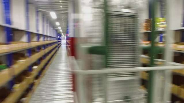 Rows of shelves with goods in Ozon company storage facilities