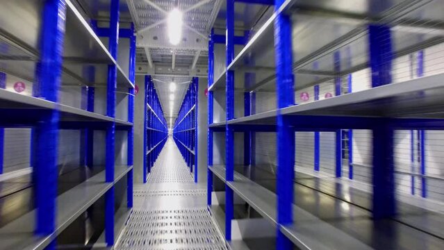 Warehouse with rows of empty shelves in logistic center