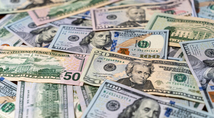 Fototapeta na wymiar Close up view of cash money, 100 one hundred US dollar bills, 50 US dollar bills, 20 US dollar bills, lots of cash. 