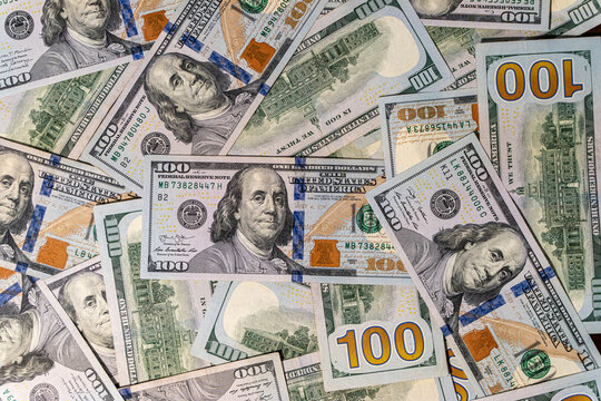 Close up view of cash money, 100 one hundred US dollar bills, 50 US dollar bills, 20  US dollar bills, lots of cash. 