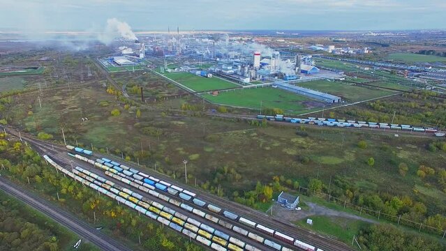 Railroad with trains not far from mineral fertilizers chemical factory 