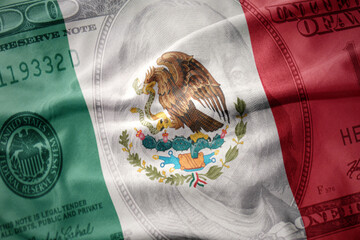 waving colorful flag of mexico on a american dollar money background. finance concept.