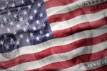 waving colorful flag of united states of america on a american dollar money background. finance concept.