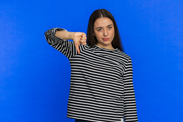 Dislike. Upset unhappy Caucasian woman showing thumbs down sign gesture, expressing discontent,...