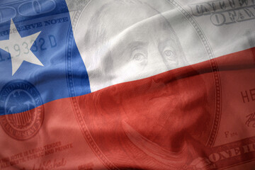 waving colorful flag of chile on a american dollar money background. finance concept.
