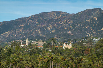 Obraz premium Santa Barbara, CA, USA - November 30, 2023: Santa Barbara County Courthouse lookout tower view on Old Mission double tower and Saint Anthony Seminary tower. Santa Ynez mountains