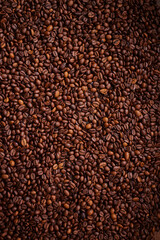 A high angle view of a pile of coffee beans spread out.