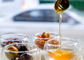 Honey spilling from spoon