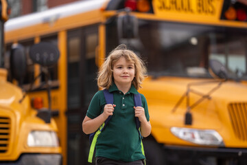 Schoolkid getting on the school bus. American School. Back to school. Kid of primary school. Happy...