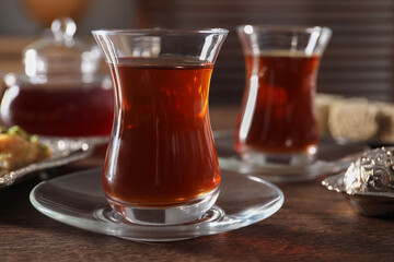 Traditional Turkish tea in glasses on wooden table, closeup