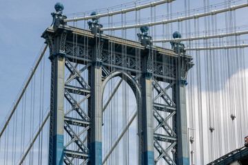 High resolution detail of the Manhattan bridge, taken from Dumbo, Brooklyn, New York. Daylight with blue sky and clouds and rich textures