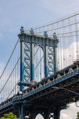 High resolution detail of the Manhattan bridge, taken from Dumbo, Brooklyn, New York. Daylight with blue sky and clouds and rich textures