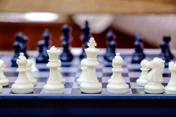 Chess pieces, white and black, set on a board, depicting the concept of teamwork, financial stability, readiness, etc.