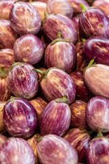 Closeup of a tray of eggplants at a farmer's market.