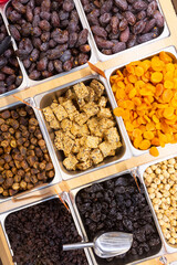 Mixed trays of dried fruit and nuts in a Middle Eastern Grocery Store. 