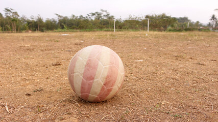 Plastic ball on dry ground field