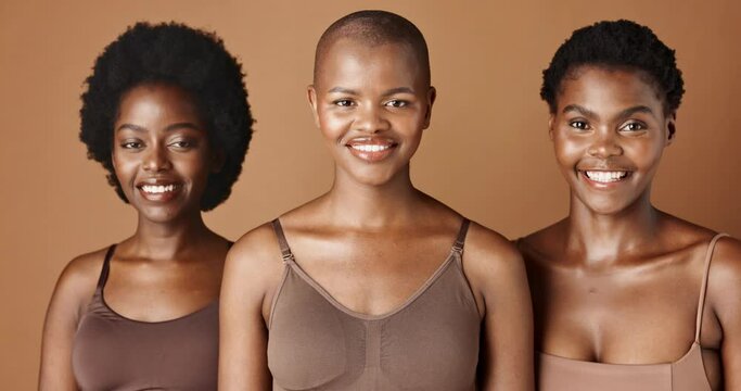 Face, Skincare And Natural With Black Woman Friends In Studio On A Brown Background For A Wellness Routine. Portrait, Aesthetic And Smile With A Group Of People Looking Happy At Beauty Treatment