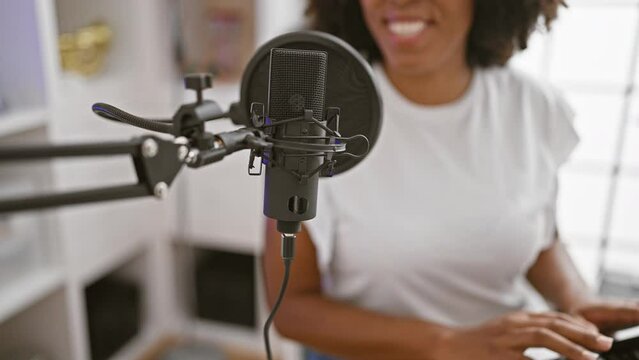 African-american woman recording in music studio